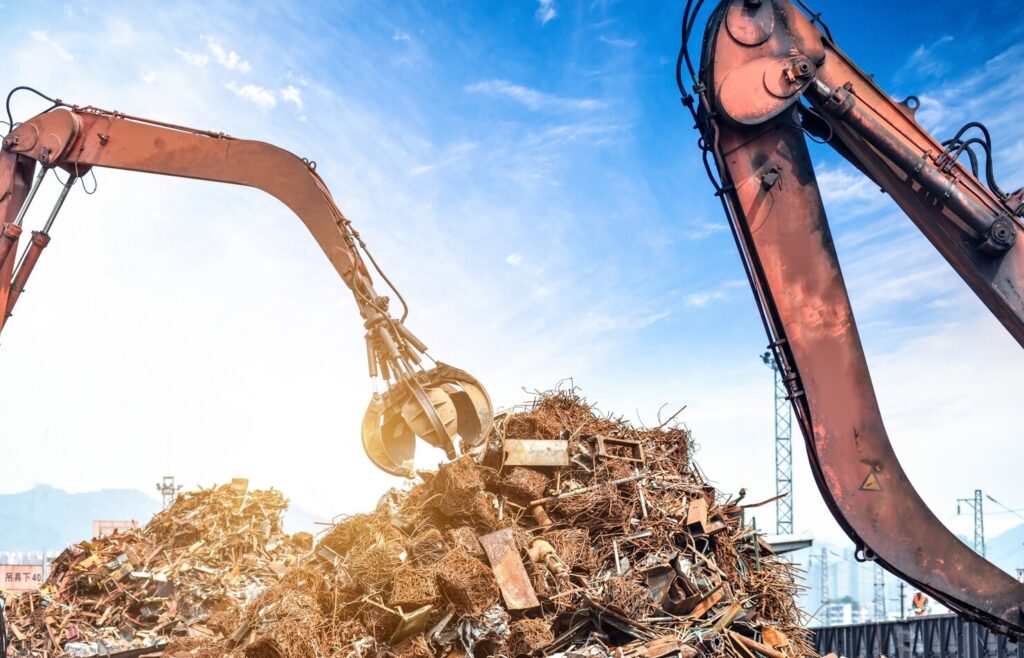 Heavy crane grab loading scrap metal for commercial junk removal in Murfreesboro TN
