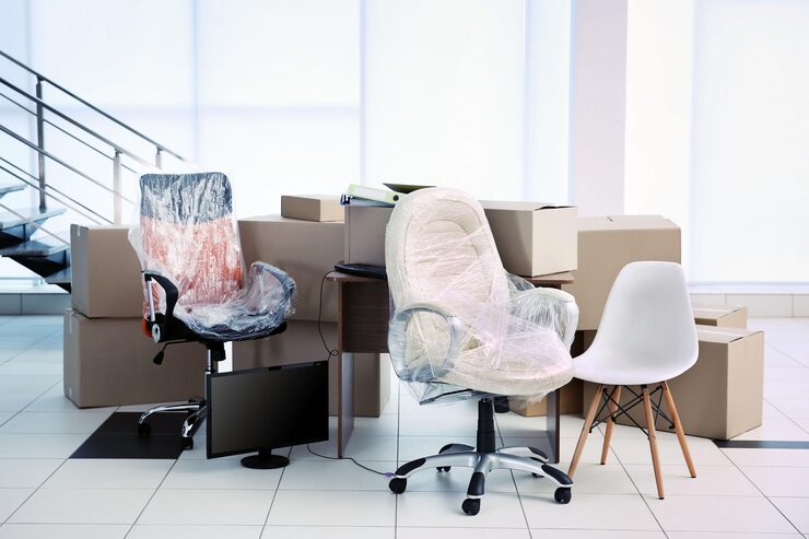 Wrapped office chairs desks and moving boxes during an office cleanout in Murfreesboro TN