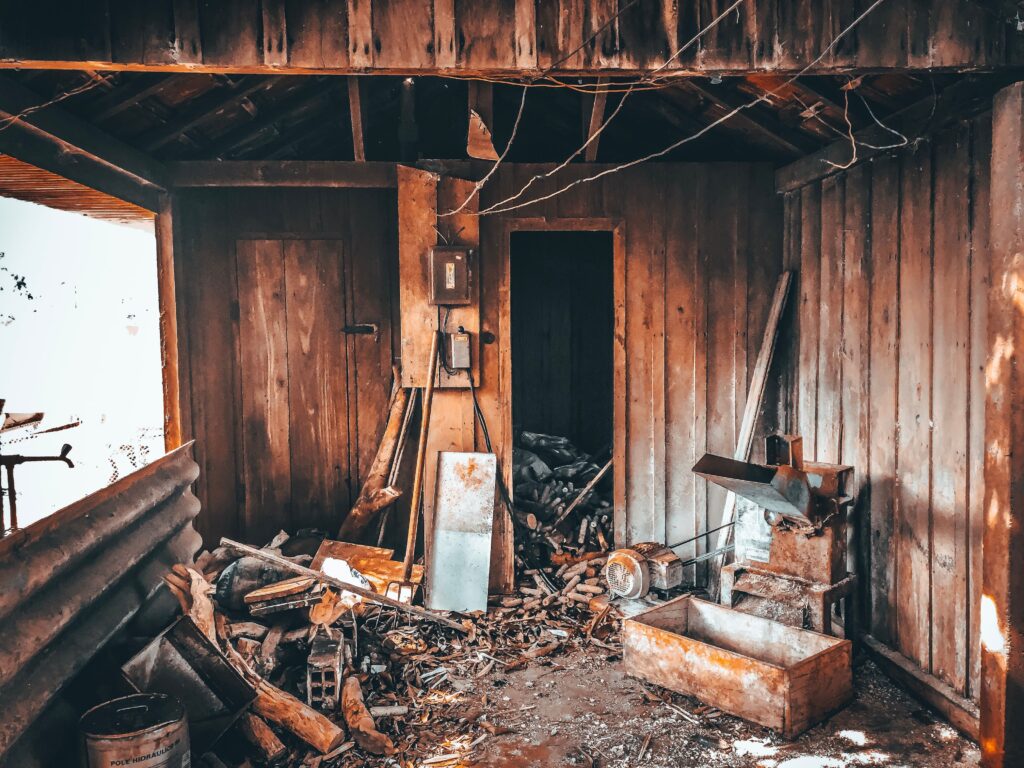 Inside an old wooden shed with rotting boards, ready for demolition