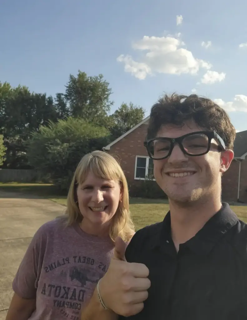 Happy customer with a BoroBoys Junk Removal crew member after a residential junk removal job